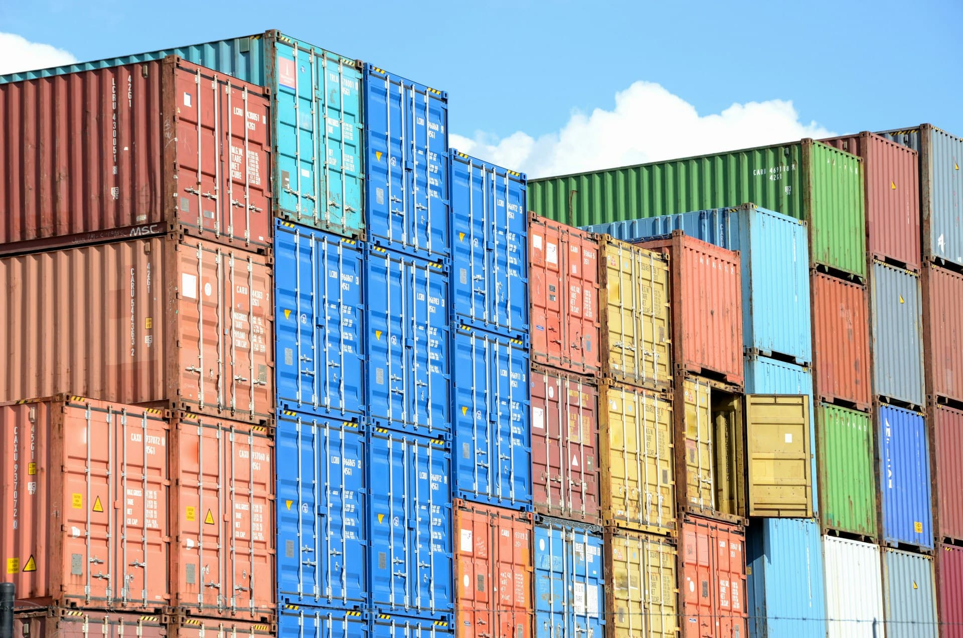 Colorful shipping containers stacked in a container yard